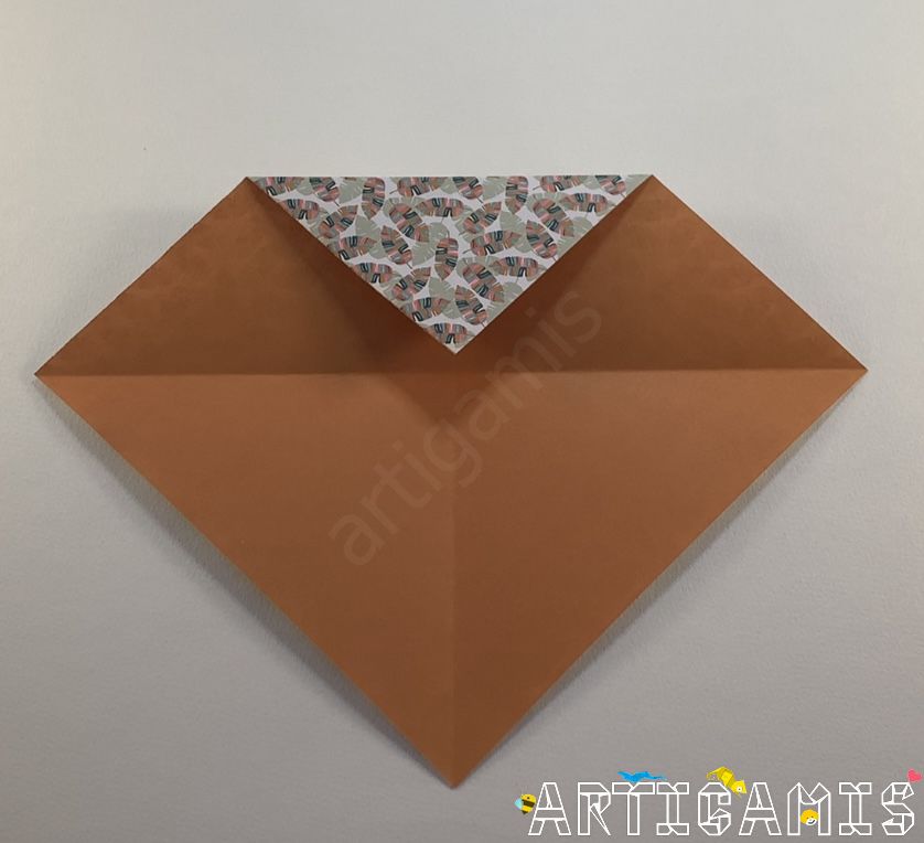 Step 3: Fold the top point over the middle intersection.